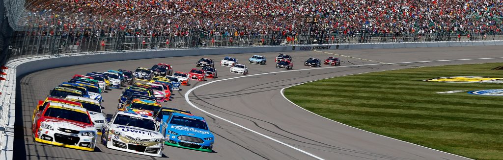 KANSAS CITY, KS - OCTOBER 05: Kevin Harvick, driver of the #4 Budweiser Chevrolet, and Brian Vickers, driver of the #55 Aaron's Dream Machine Toyota, lead the field at the start of the NASCAR Sprint Cup Series Hollywood Casino 400 at Kansas Speedway on October 5, 2014 in Kansas City, Kansas. (Photo by Matt Sullivan/NASCAR via Getty Images)